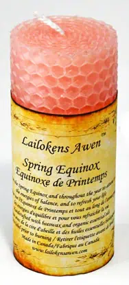 Candle with honeycomb pattern and a label reading "Lailokens Awen Spring Equinox.".