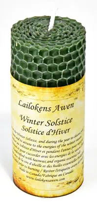 Celtic winter solstice candle with honeycomb design and a printed label.