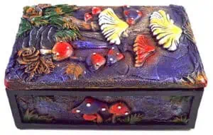 Wooden box with carved mushrooms and nature-inspired designs.