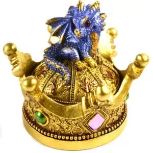 Detailed image of a small blue and gold dragon figurine perched on a decorative golden crown with ge.