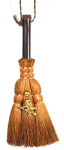 A wooden wand with a brass bird-shaped pendant and twine wrapping, used in Celtic spiritual practice.
