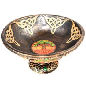 Decorative bowl featuring Celtic knot patterns and a colorful tree motif at the center.