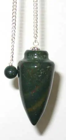 Pendant necklace with green stone, chain, and bead, emphasizing natural mineral textures.