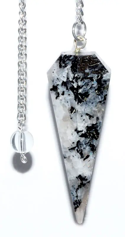 Pendulum with black and white speckled stone on silver chain.