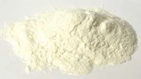 Fine white powder, possibly flour or chalk, on a plain background.