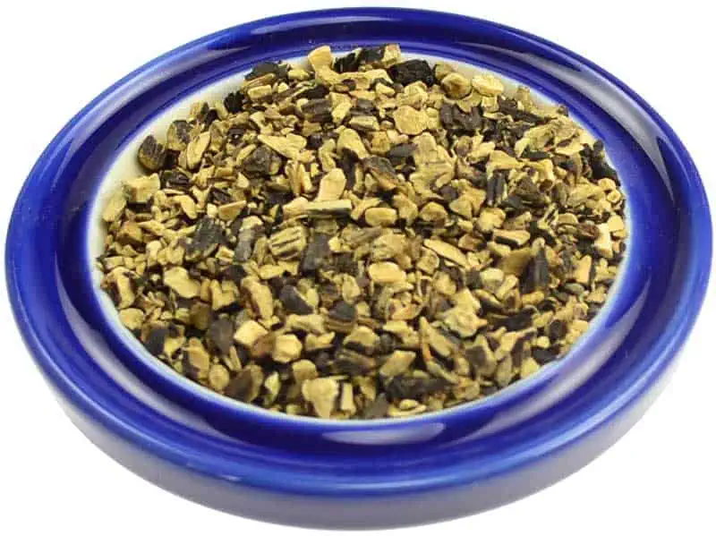 Close-up of herbal mixture in a blue bowl, used in Celtic spiritual practices.
