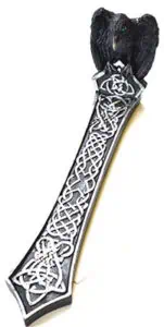 A detailed image of a dagger featuring Celtic knotwork and a black carved handle.