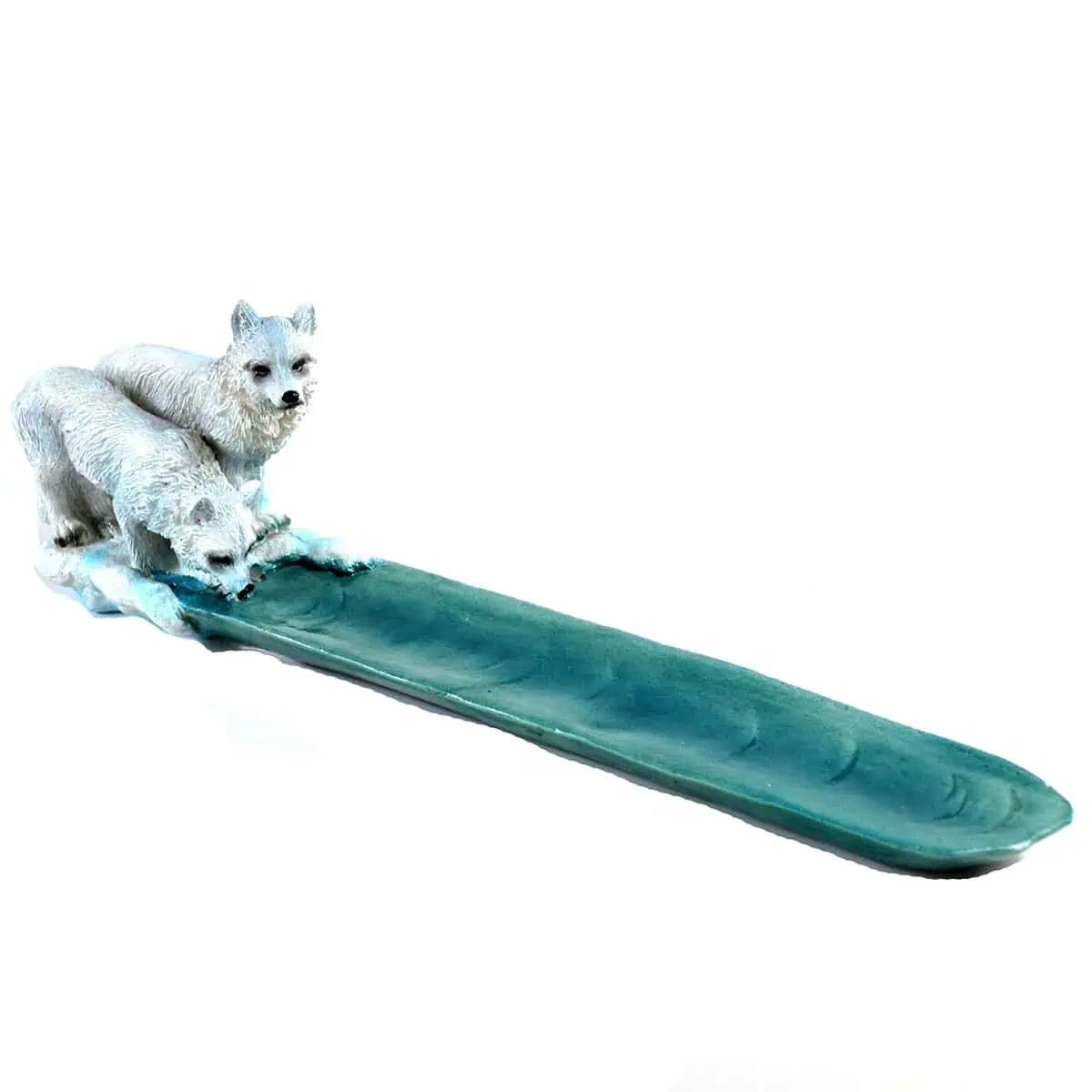 Wolf figurines on a green surfboard, representing harmony with nature and Celtic spiritual symbolism.