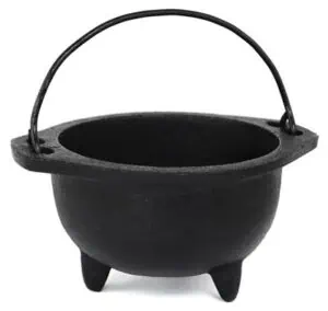 Small black cauldron with handle, used in Celtic spiritual practices and rituals.