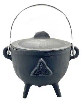 Small black cauldron with a triangular knot symbol, metal handle, and three legs, used in Celtic spi.