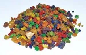 Colorful resin granules used in crafts and jewelry making.