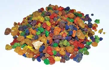 Colorful resin granules used in crafts and jewelry making.