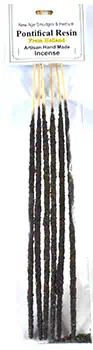 A close-up of a bundle of incense sticks with black and white stripes, ready for use in spiritual or.