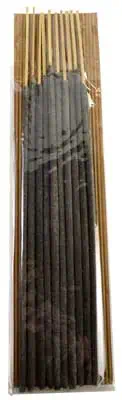Incense sticks arranged in a wooden box, used for spiritual practices and rituals.