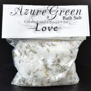 Bath salt with dried herbs and floral elements.