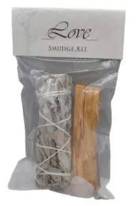 A smudge kit with sage and a wooden stick for cleansing and spiritual practices.
