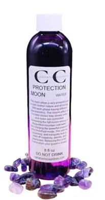 Bottle of Celtic Moon Protection spray surrounded by amethyst stones, used for spiritual protection.
