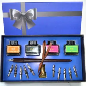 Ink set with four bottles of colored ink, a dip pen, and nibs in a gift box.