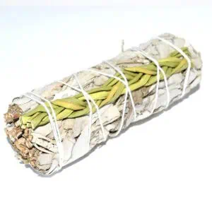 Sacred smudging bundle with sage and herbs for spiritual cleansing and rituals.