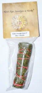 Cedar smudge stick in plastic packaging, used for spiritual cleansing and nature-based practices.