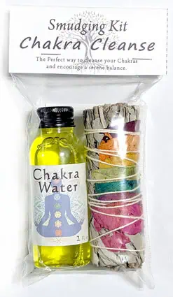 Chakra cleansing smudging kit with herbs and essential oil for spiritual practice.