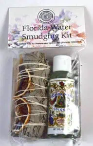 Smudging kit with dried herbs, Florida Water bottle, and floral packaging for spiritual cleansing.
