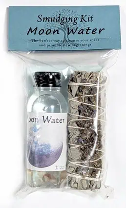 A small bottle of moon water and a bundle of dried herbs for spiritual cleansing and rituals.
