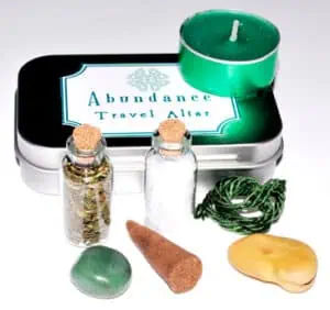 Travel altar with candles, stones, and natural objects for Celtic spirituality practices.