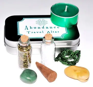 Travel altar with candles, stones, and natural objects for Celtic spirituality practices.