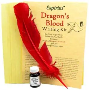 A red feather quill, ink bottle, and parchment paper for mystical writing and rituals.
